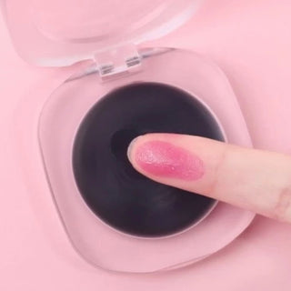 A finger gently swipes across the Color-Changing Blush, showcasing its smooth, silky texture as it adapts to the skin. 