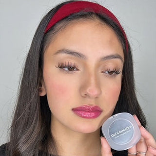 A model wearing the Color-Changing Blush, showcasing its ability to adapt to her skin tone, providing a natural pink or peach glow. 