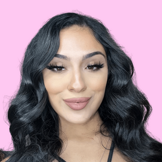 Model wearing the savage lashes style in a pink background